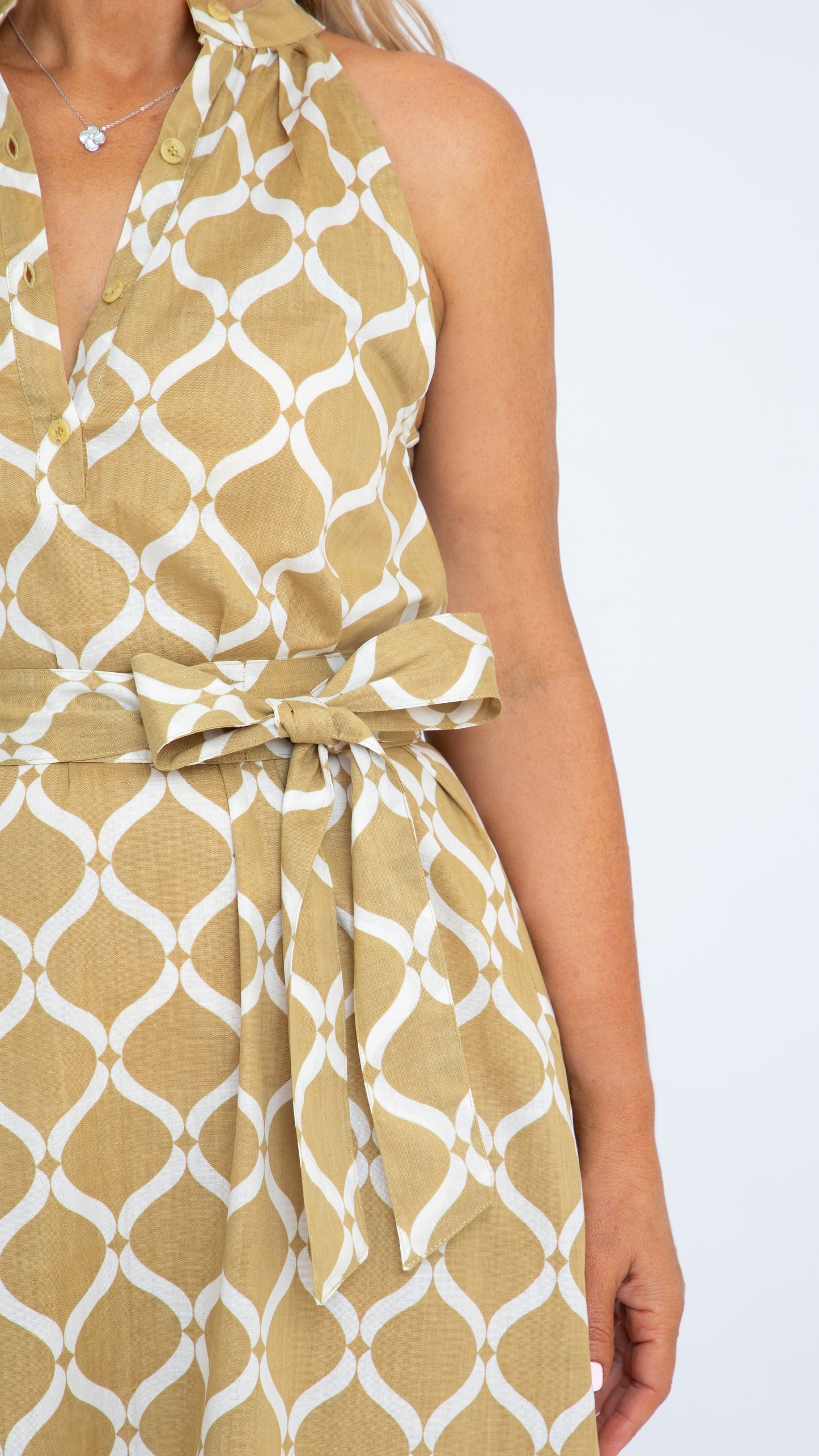 Close up of neckline and self-tie belt on Donna dress by Nancy The Label. Made in a Gold Trellis cotton which is on a white background. 100% cotton