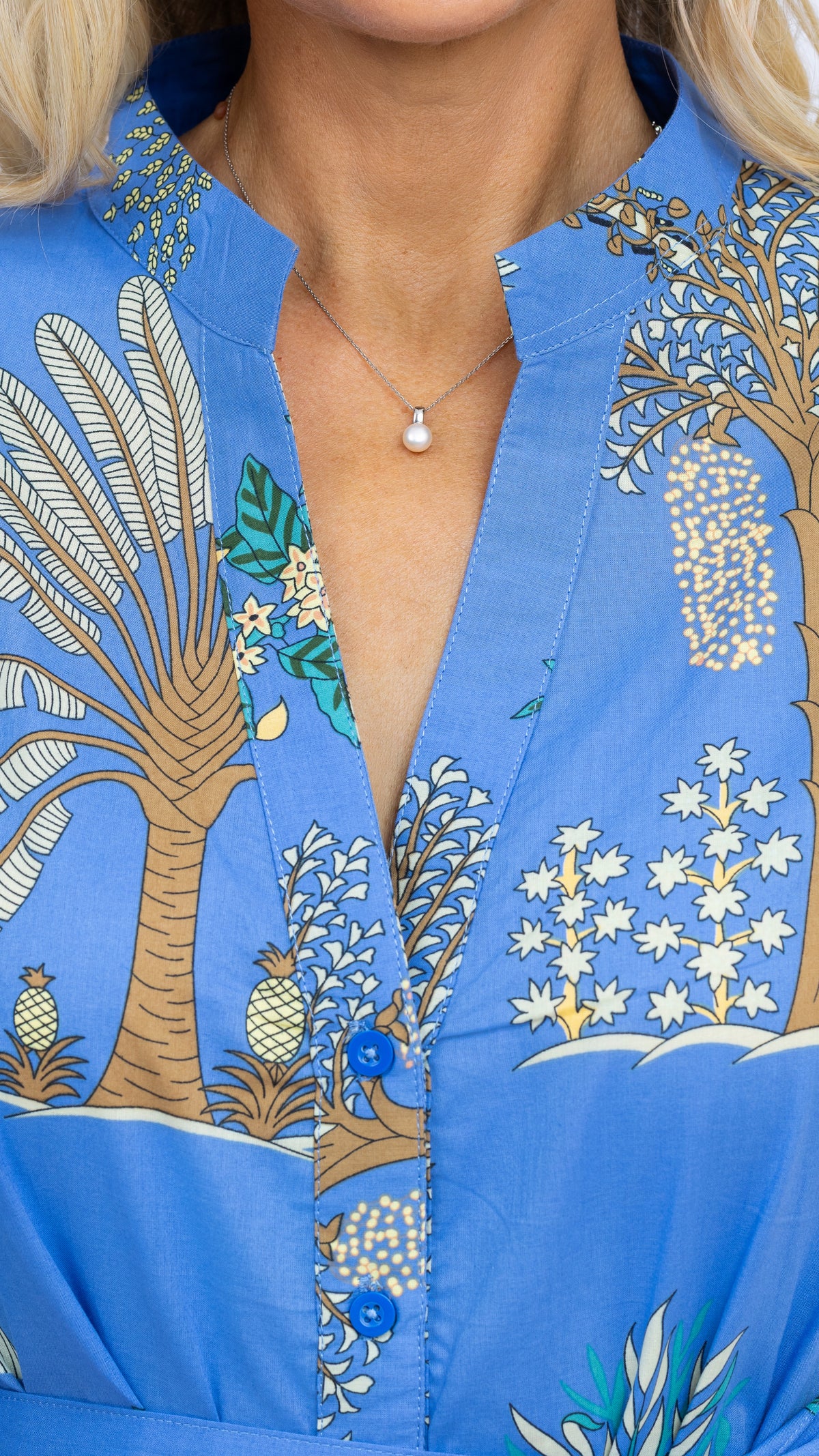 Close-up of the neckline and button-front detail on the Mandy maxi dress by Nancy The Label in blue Arboretum botanical print, made from 100% cotton.
