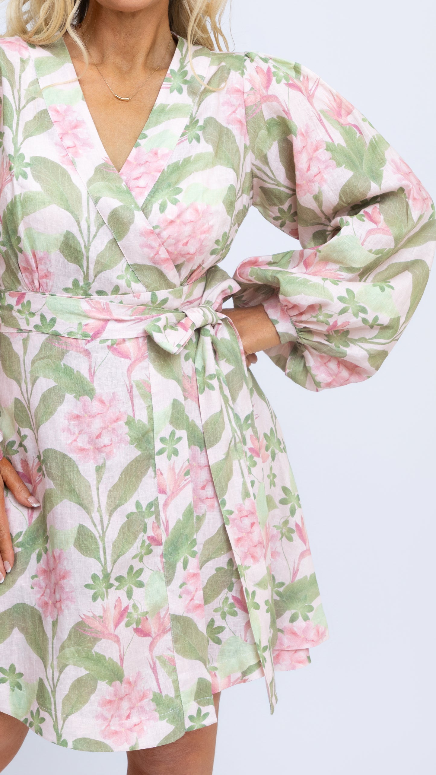 A close up view of Nancy The Label's Margot Linen Mini Wrap Dress in our bespoke Tropical Botanica print